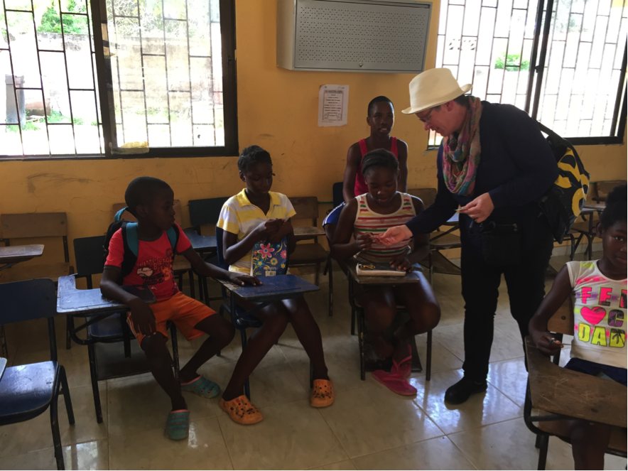 Photograph of Jutta interacting with students in a classroom in Palenque